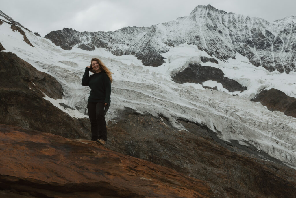 Local Swiss elopement photographer standing in front of a Swiss mountain glacier
