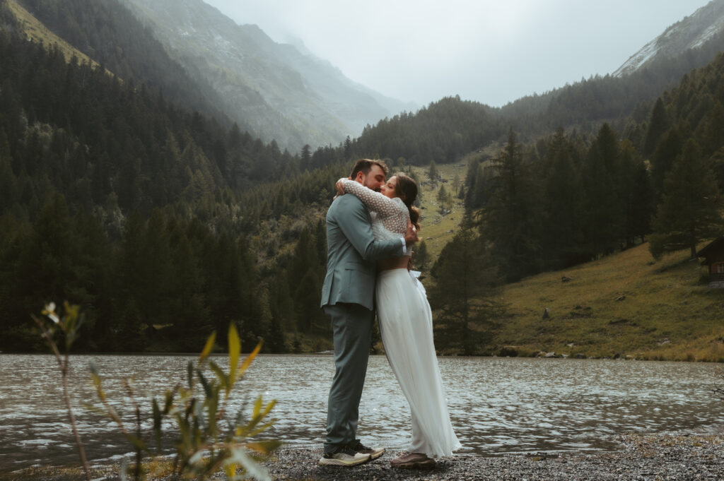 A bride hugs her groom during their elopement in the swiss alps
