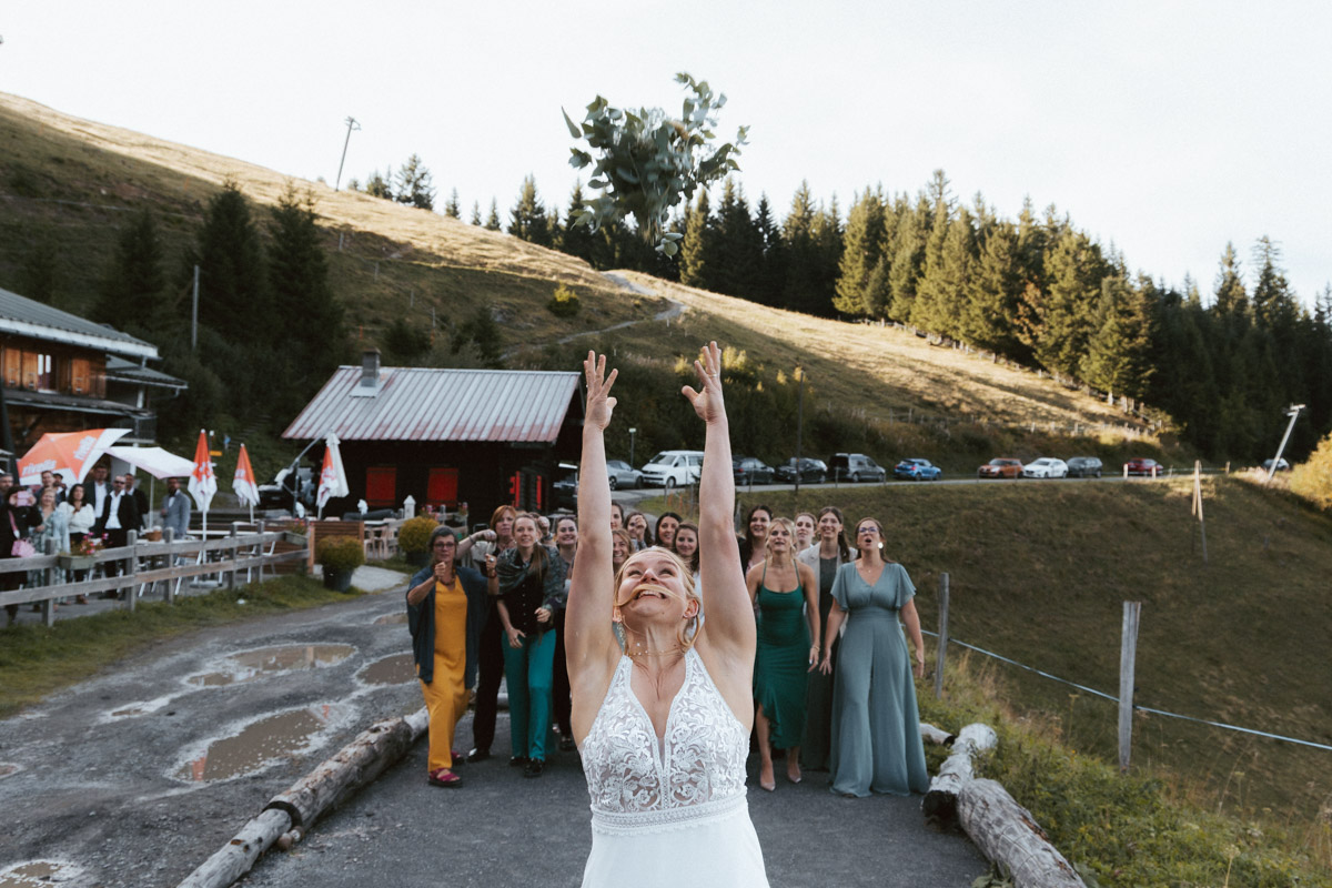 A bride throws her bouquet to her friends.