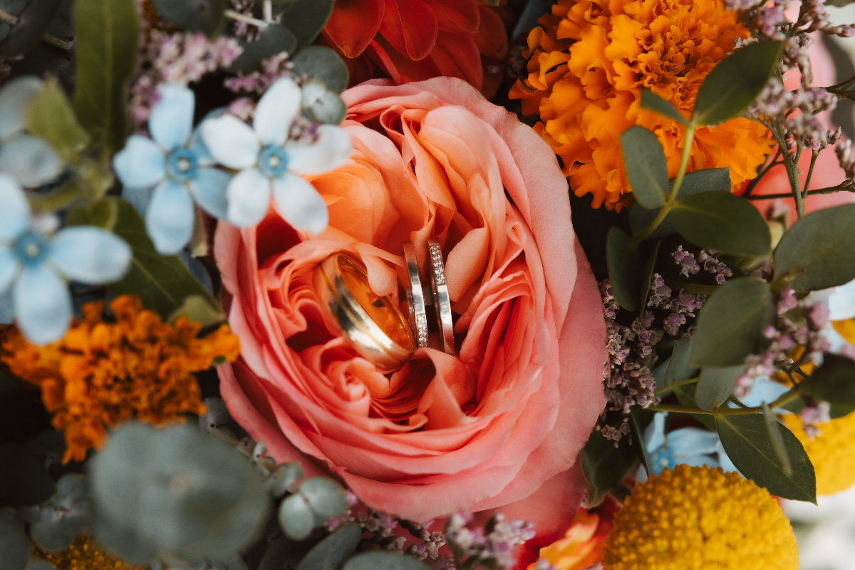 Close-up of wedding rings in a flower bouquet
