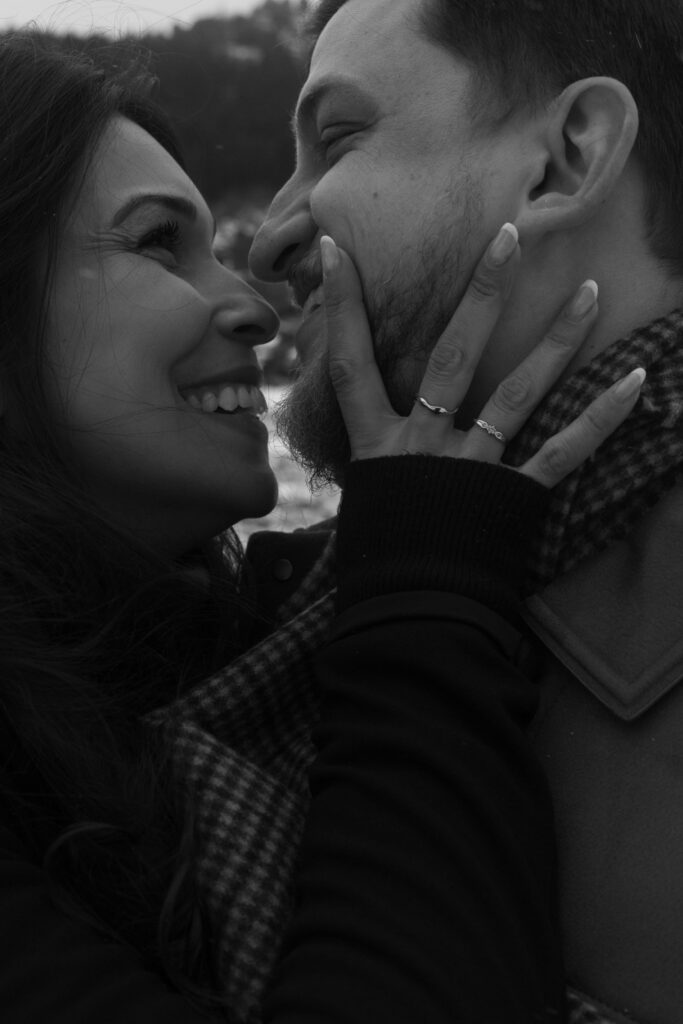 Close up of a couple embracing; the woman holds her partner's face gently in her hands